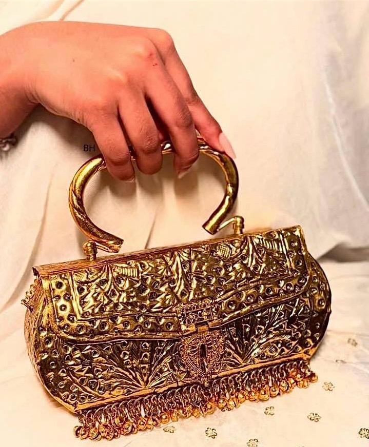 Devyani golden clutch